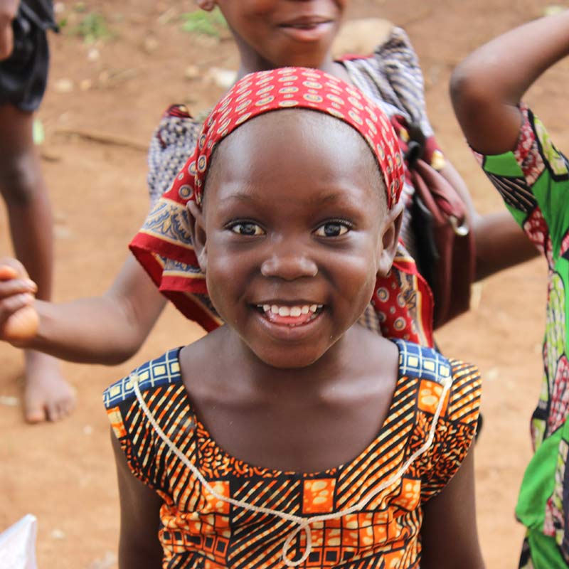 Young girl in Africa with a colorful dress on.